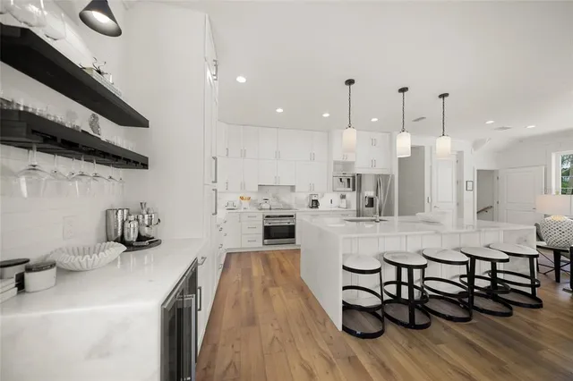 a large kitchen with a table and chairs