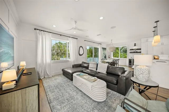 a living room with furniture wooden floor and a window