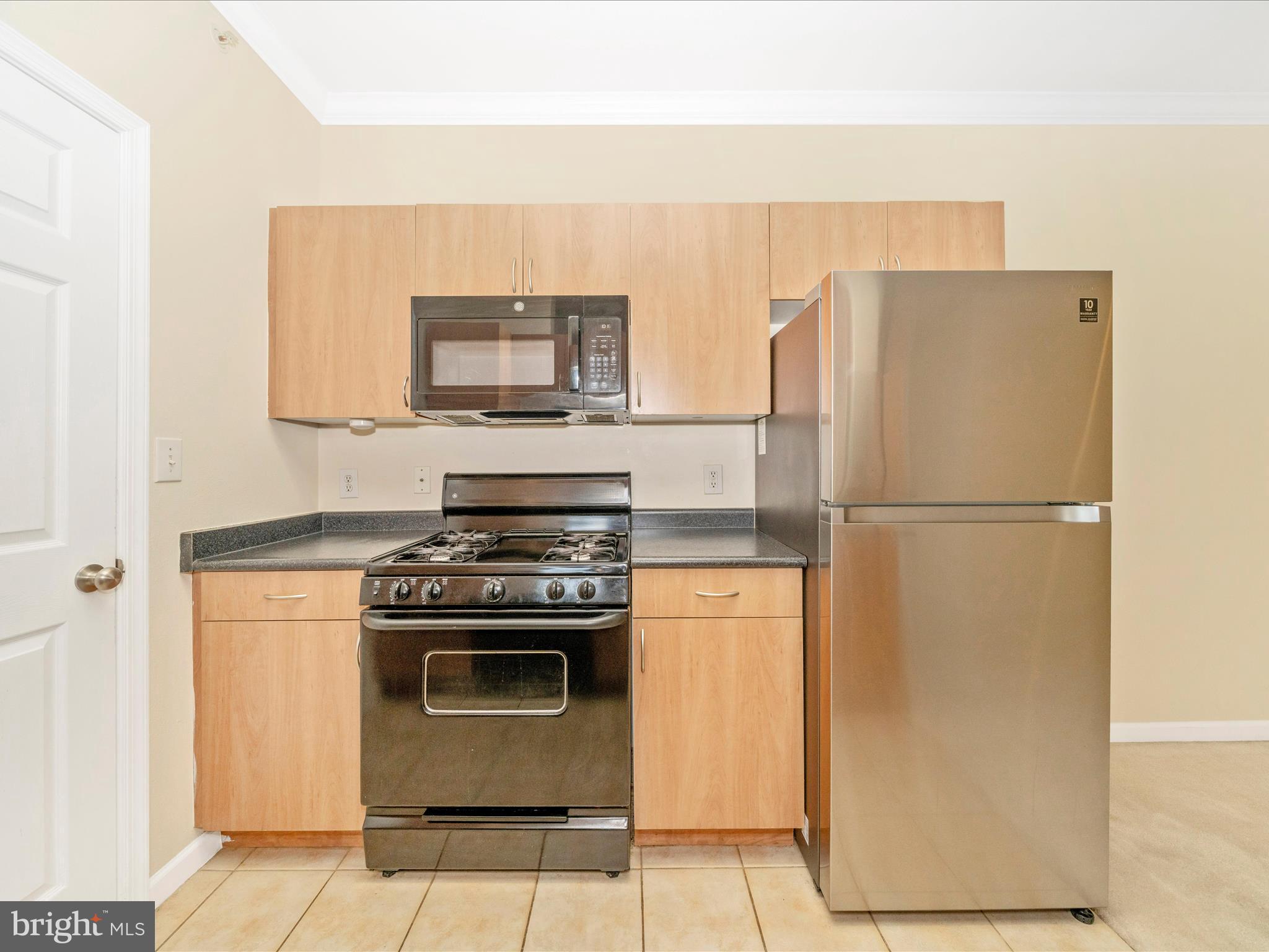 19606 Galway Bay Circle, Unit 401 Germantown, MD 20874 - Photo 13 of 50 a kitchen with a stove top oven and a refrigerator