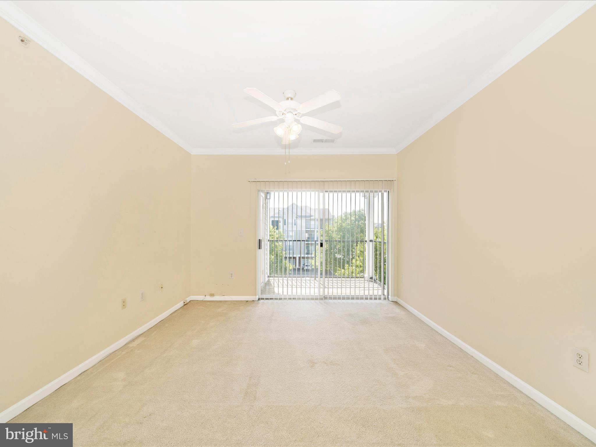 19606 Galway Bay Circle, Unit 401 Germantown, MD 20874 - Photo 18 of 50 an empty room with a windows and a ceiling fan