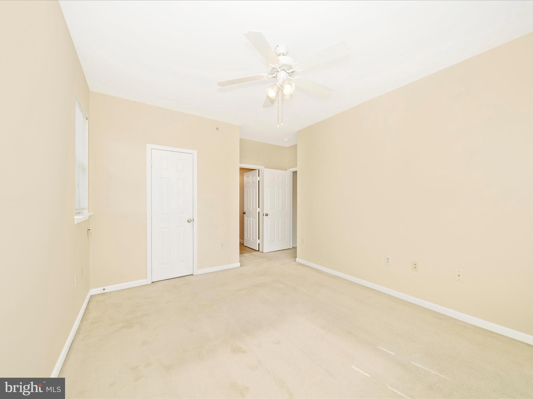 19606 Galway Bay Circle, Unit 401 Germantown, MD 20874 - Photo 24 of 50 a view of an empty room with a chandelier fan