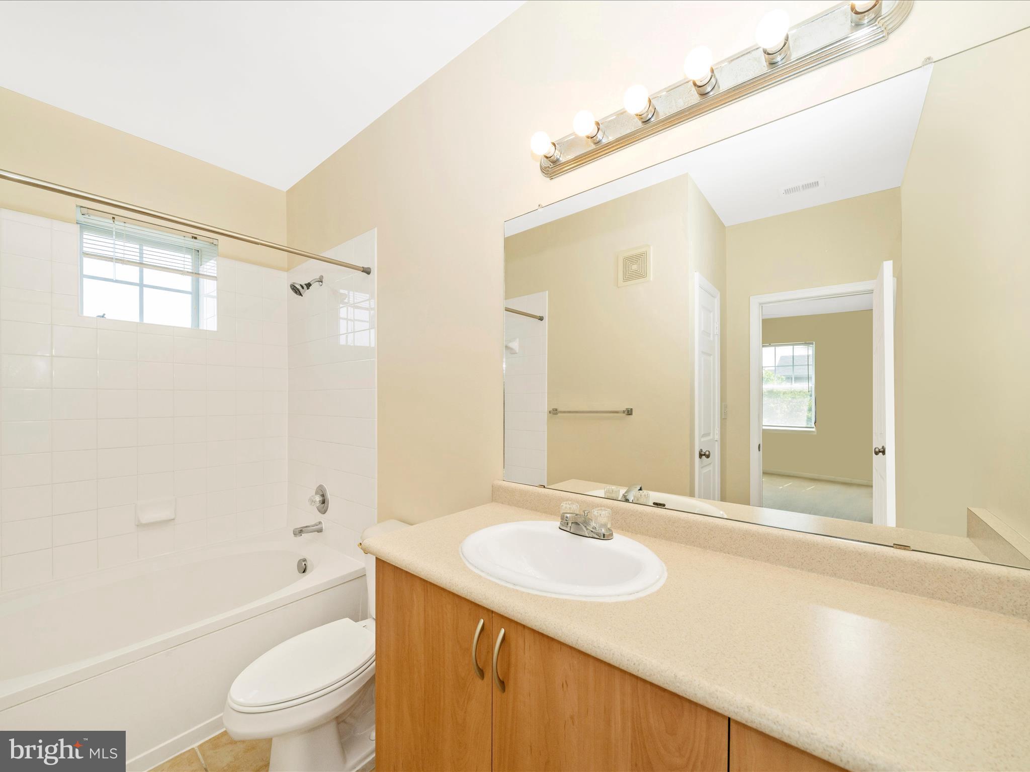 19606 Galway Bay Circle, Unit 401 Germantown, MD 20874 - Photo 29 of 50 a bathroom with a sink toilet tub and shower