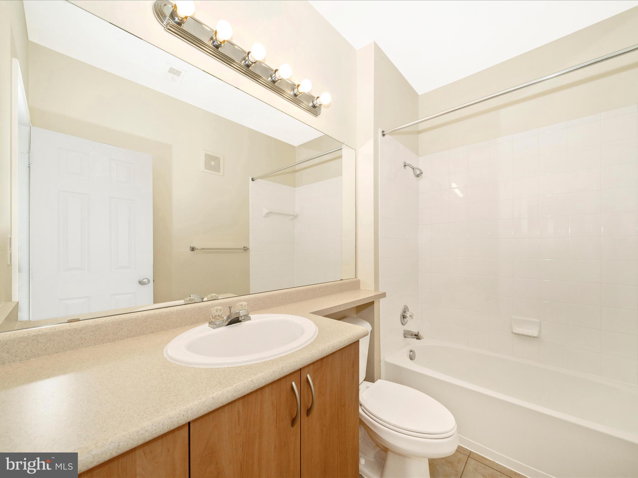 19606 Galway Bay Circle, Unit 401 Germantown, MD 20874 - Photo 36 of 50 a bathroom with a granite countertop sink toilet and shower