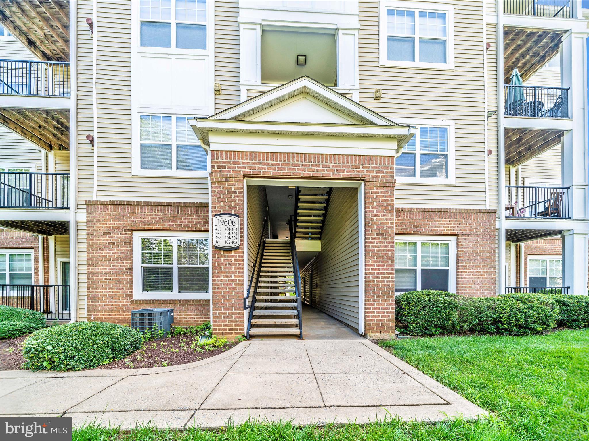 19606 Galway Bay Circle, Unit 401 Germantown, MD 20874 - Photo 50 of 50 a front view of a house with garden