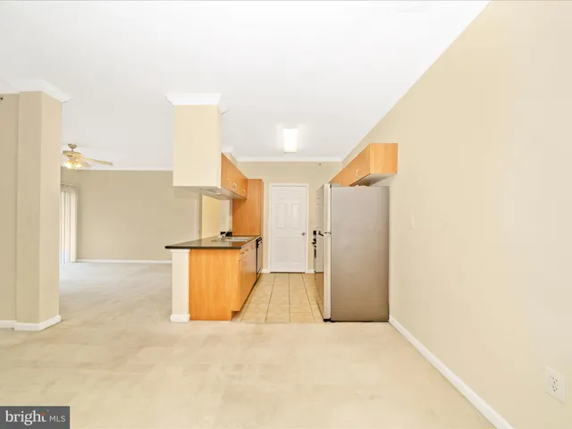 a kitchen with stainless steel appliances granite countertop a sink and a refrigerator