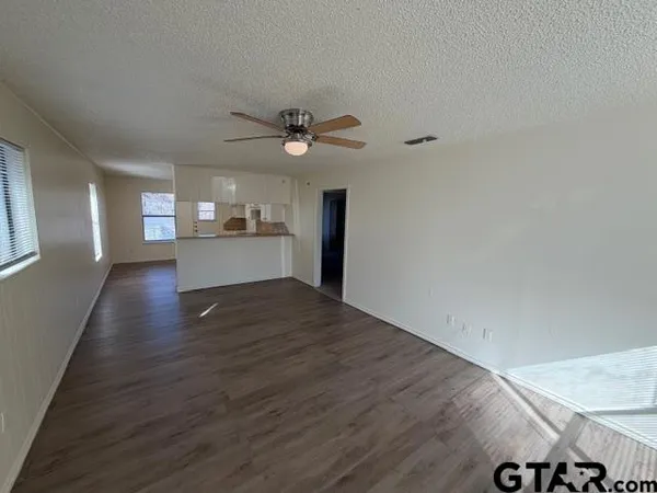 a view of kitchen and hall with wooden floor