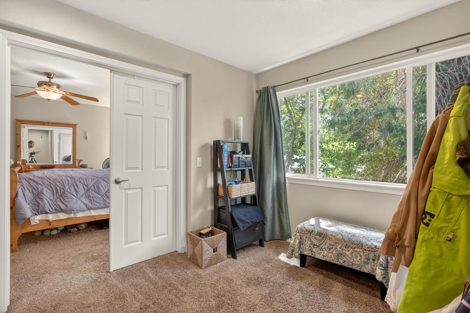 6332 Horseshoe Bar Road Loomis, CA 95650 - Photo 31 of 85 Carpeted room with a white six-panel door, multiple windows, and light-colored walls