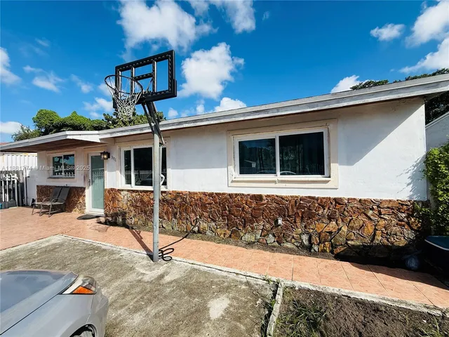 a view of a white house with large windows