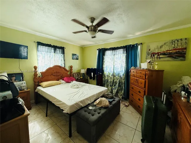a living room with furniture a flat screen tv and a table