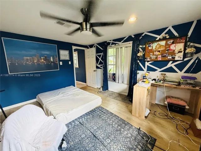 a bedroom with a bed and a mirror