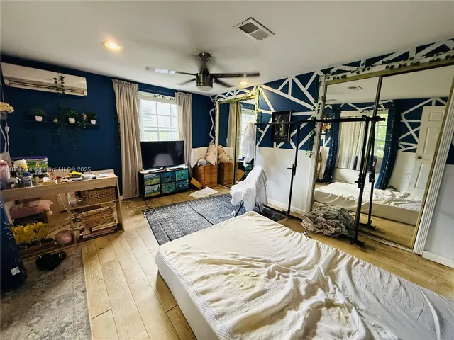 a bedroom with furniture and a mirror