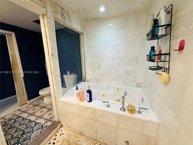 a bathroom with a bathtub and shower