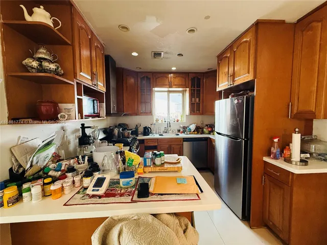 a kitchen with a refrigerator a sink and a refrigerator