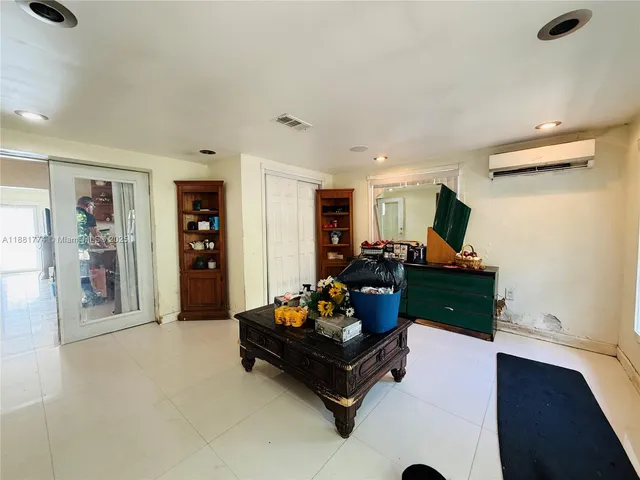 a living room with furniture gym equipment and a window