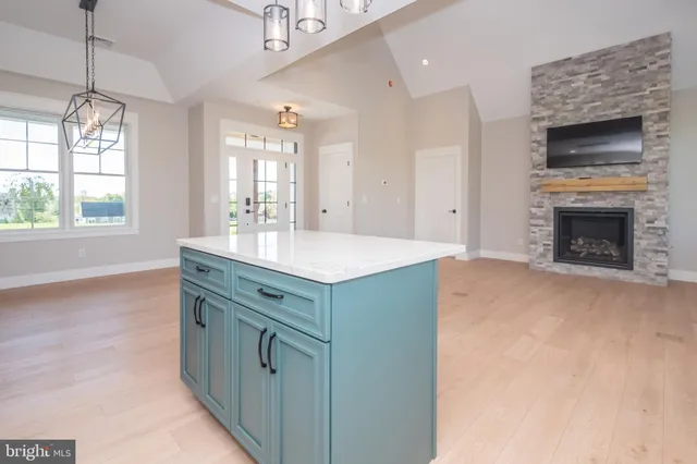 a kitchen with stainless steel appliances white cabinets and a stove top oven