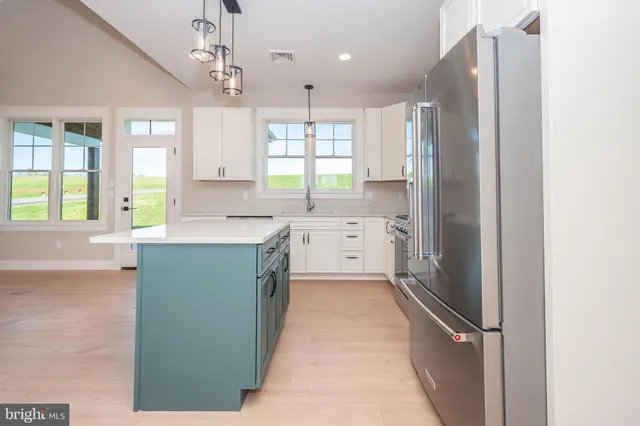 a kitchen with stainless steel appliances a refrigerator a sink dishwasher stove and oven