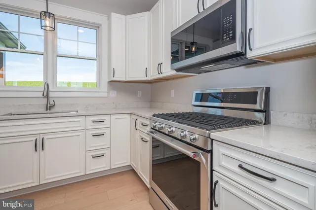 a view of a kitchen with a stove cabinets and a fireplace