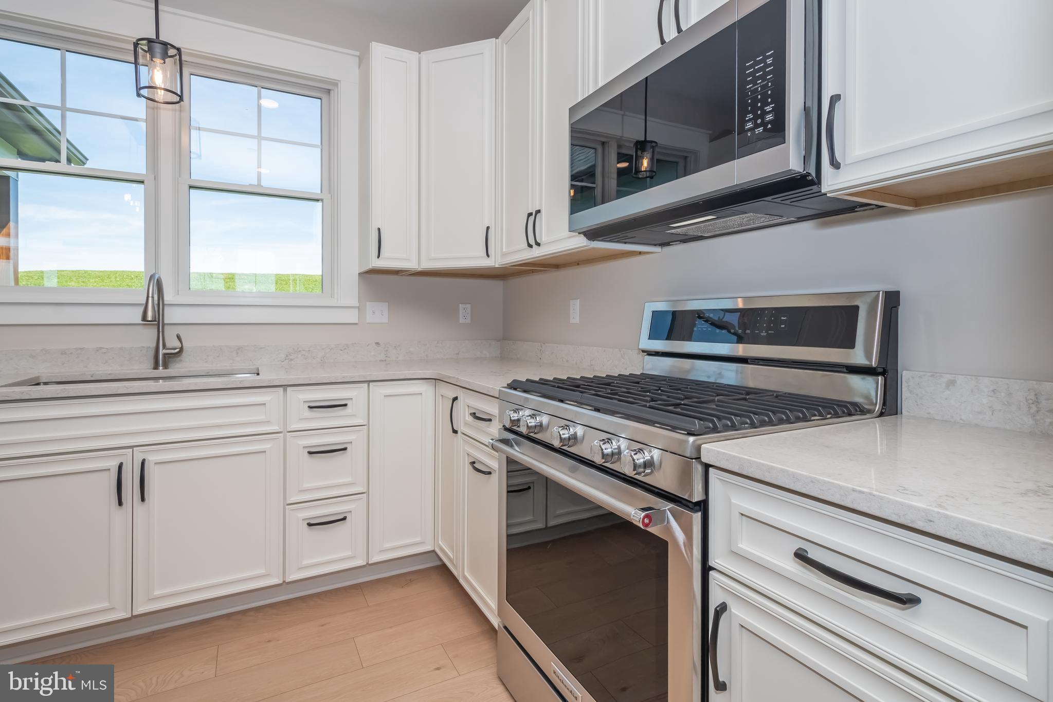71 Walnut Ridge Grantsville, MD 21536 - Photo 18 of 55 a kitchen with stainless steel appliances white cabinets and a stove top oven