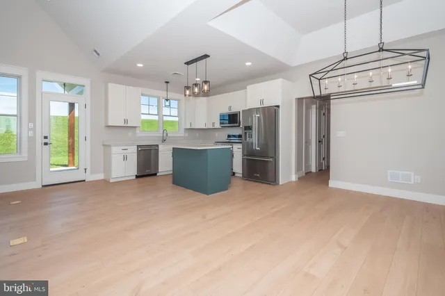 a view of a kitchen with microwave and cabinets