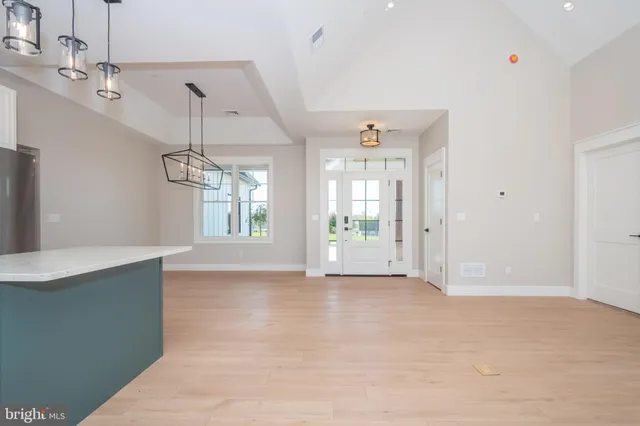 a view of an empty room with a fireplace and a window