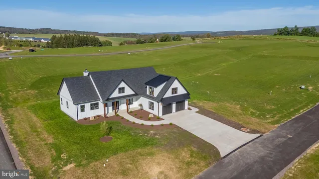 a front view of a house with a yard table and chairs