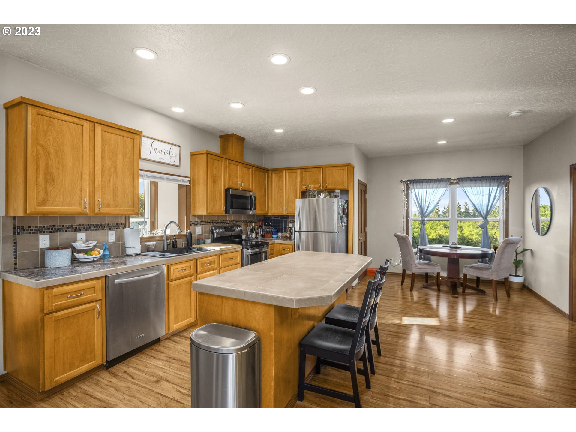 4185 Southwest Lafollett Road Cornelius, OR 97113 - Photo 41 of 45 a kitchen with stainless steel appliances granite countertop wooden cabinets a dining table and chairs