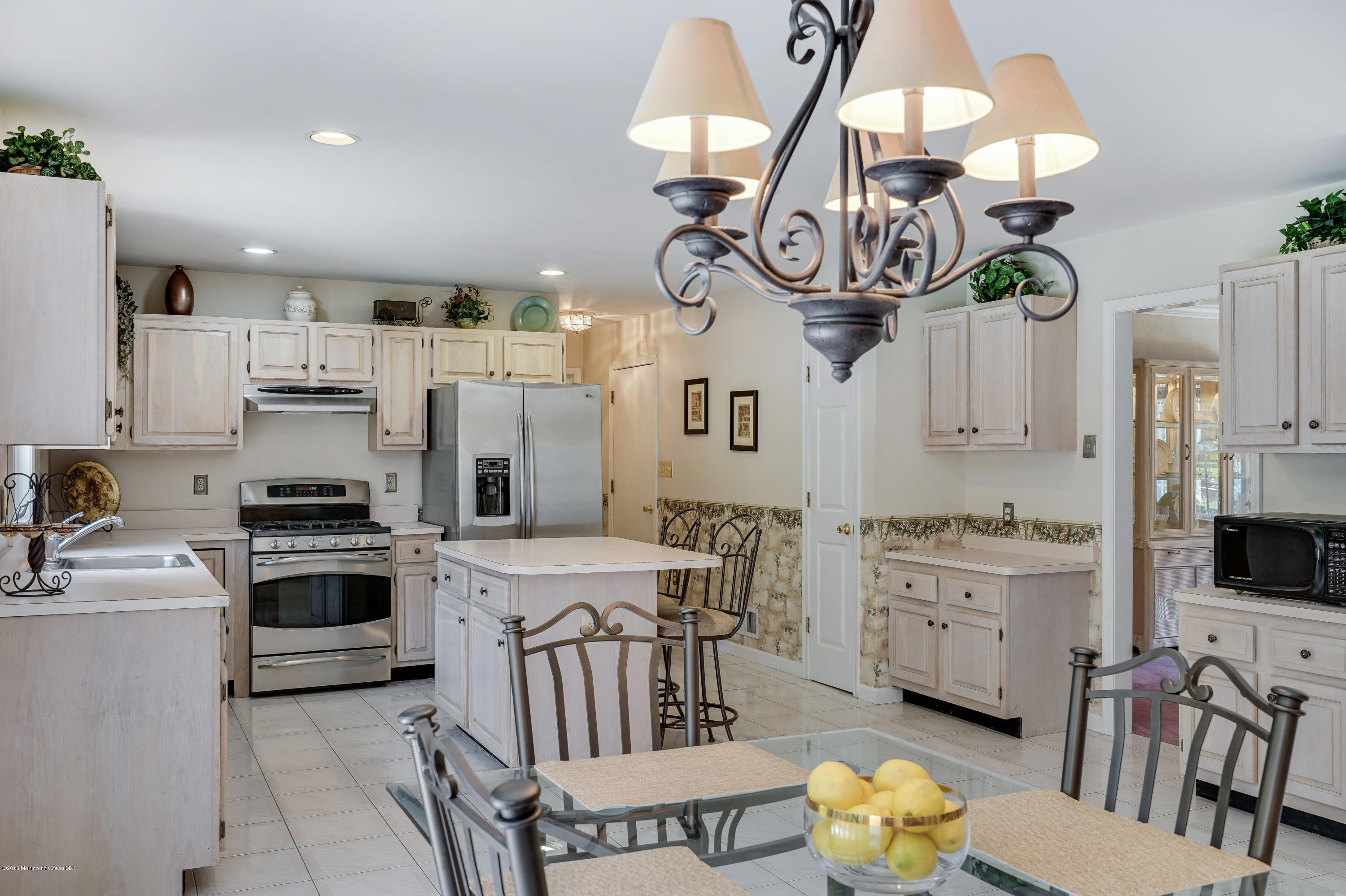 6 Overlook Drive Jackson, NJ 08527 - Photo 21 of 50 a kitchen with stainless steel appliances granite countertop a stove a sink dishwasher a dining table and chairs with wooden floor