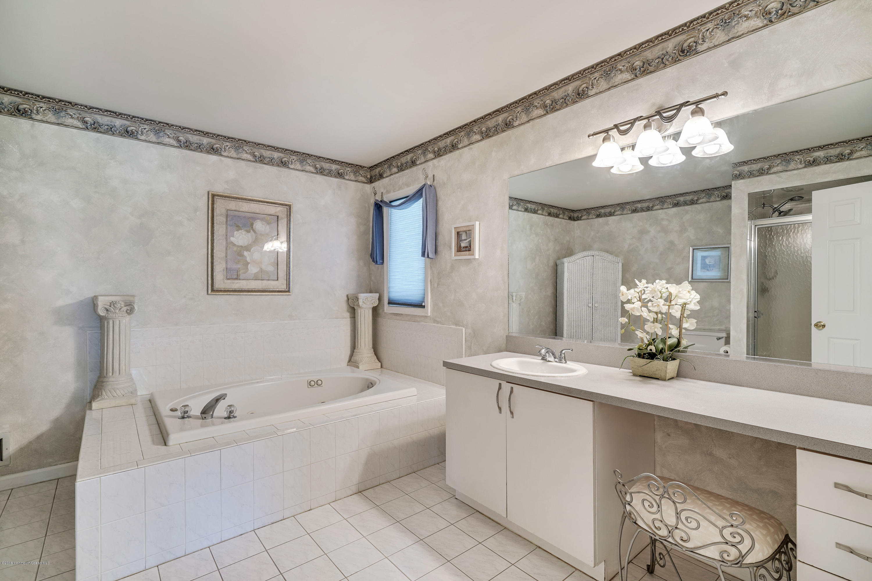 6 Overlook Drive Jackson, NJ 08527 - Photo 36 of 50 a bath room with a mirror and a chandelier