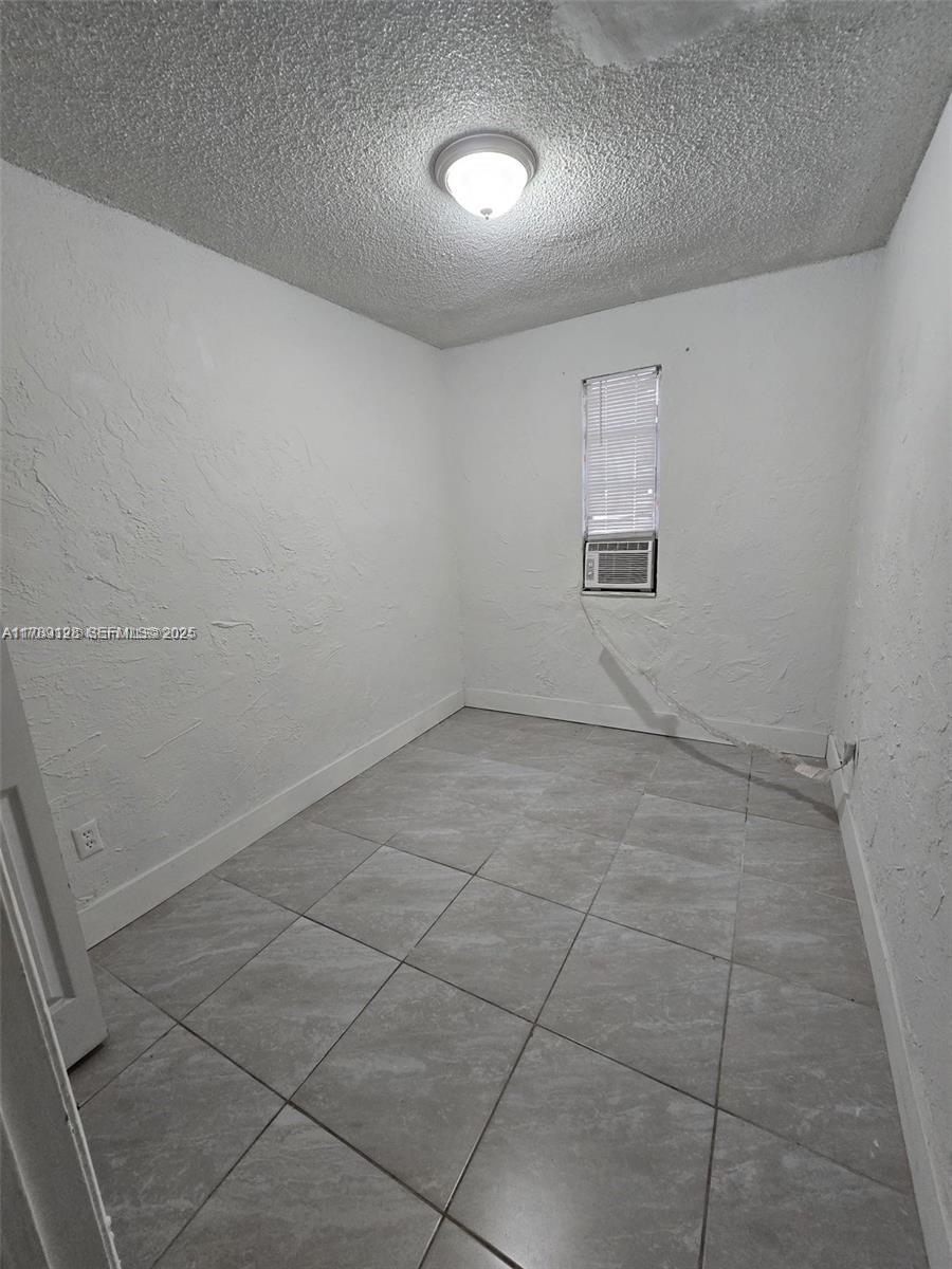 626 Northwest 22nd Road Fort Lauderdale, FL 33311 - Photo 2 of 3 an empty room with a empty space and windows