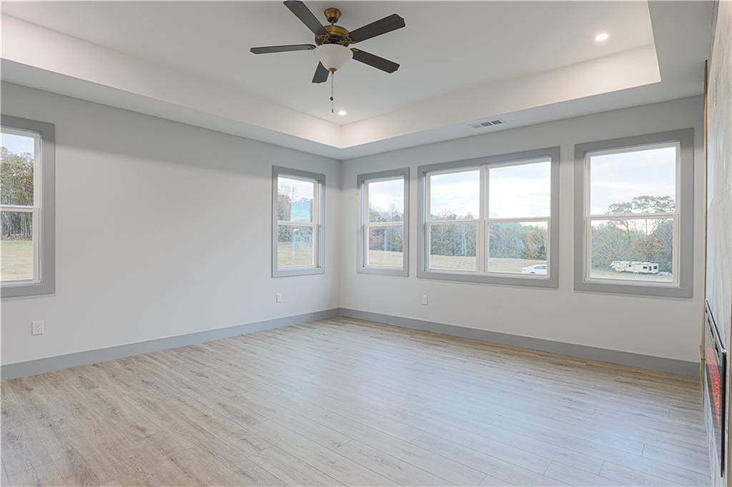 1341 Wheeler Creek Road Maysville, GA 30558 - Photo 43 of 51 a view of an empty room with a window and wooden floor