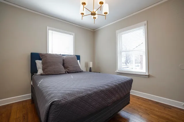 a large bed sitting in a bedroom next to a window