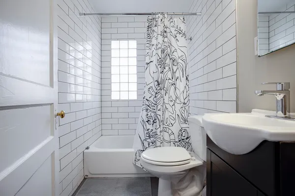 a bathroom with a sink a toilet and bathtub