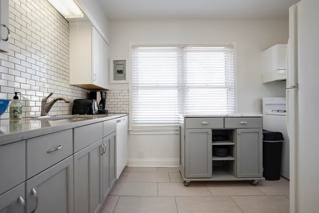 a kitchen with stainless steel appliances granite countertop a sink and a stove