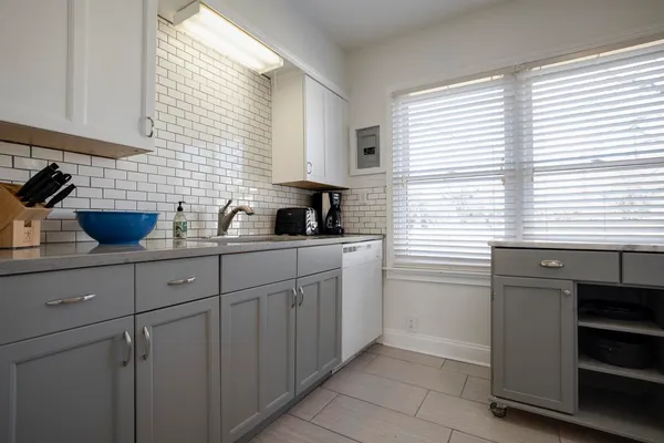a kitchen with a sink a window and cabinets
