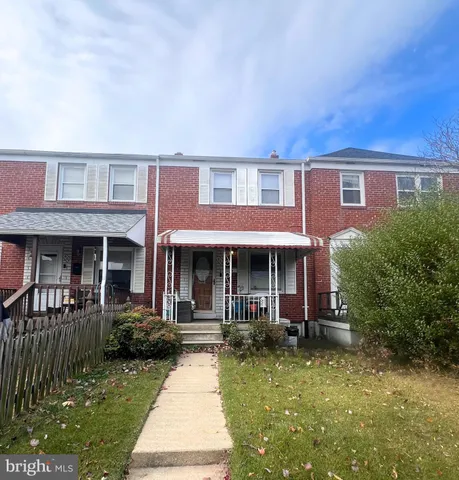 a front view of a house with yard porch and furniture