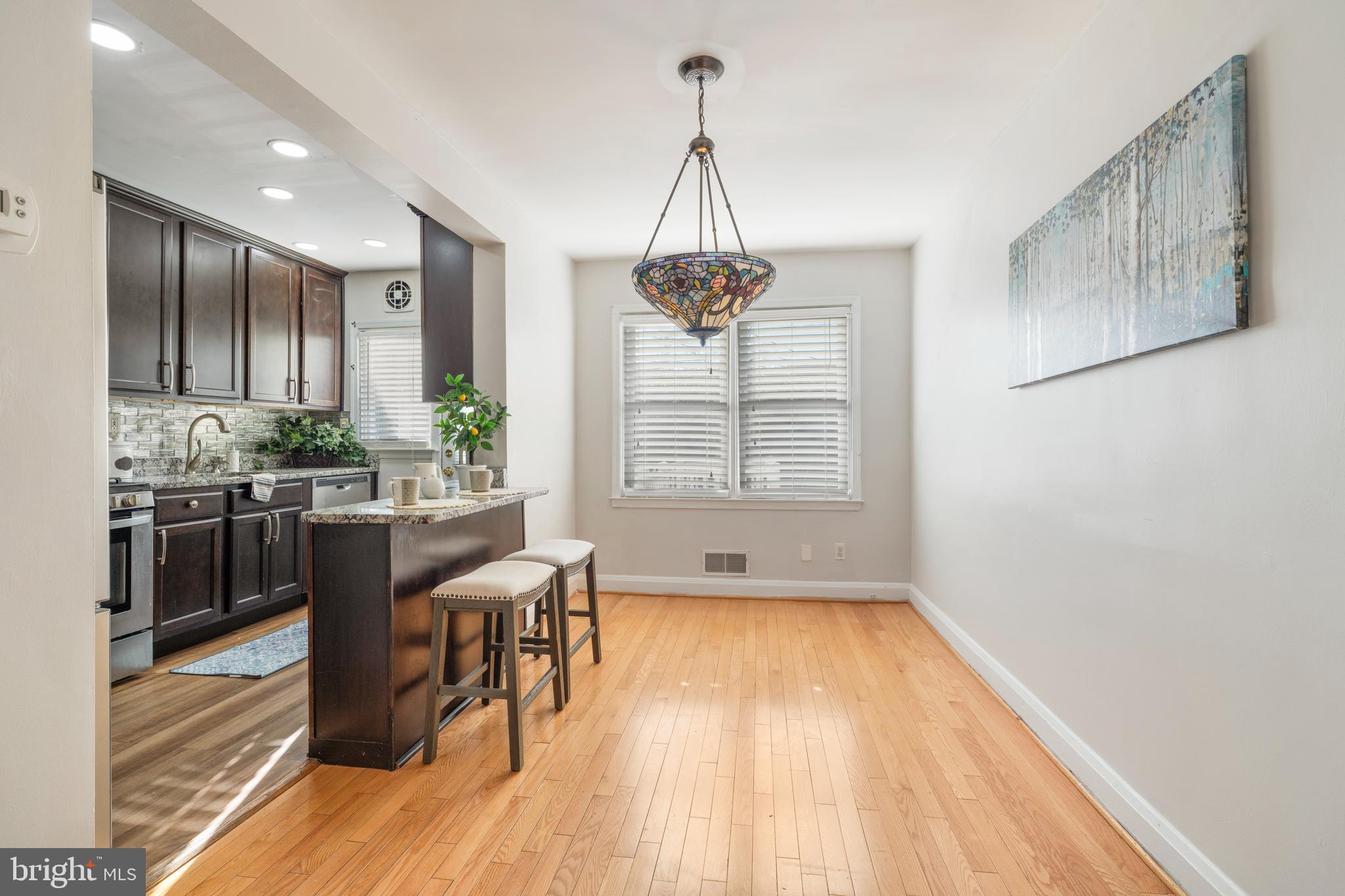 404 Grovethorn Road Baltimore, MD 21220 - Photo 11 of 39 a kitchen with stainless steel appliances granite countertop a stove and a wooden floors