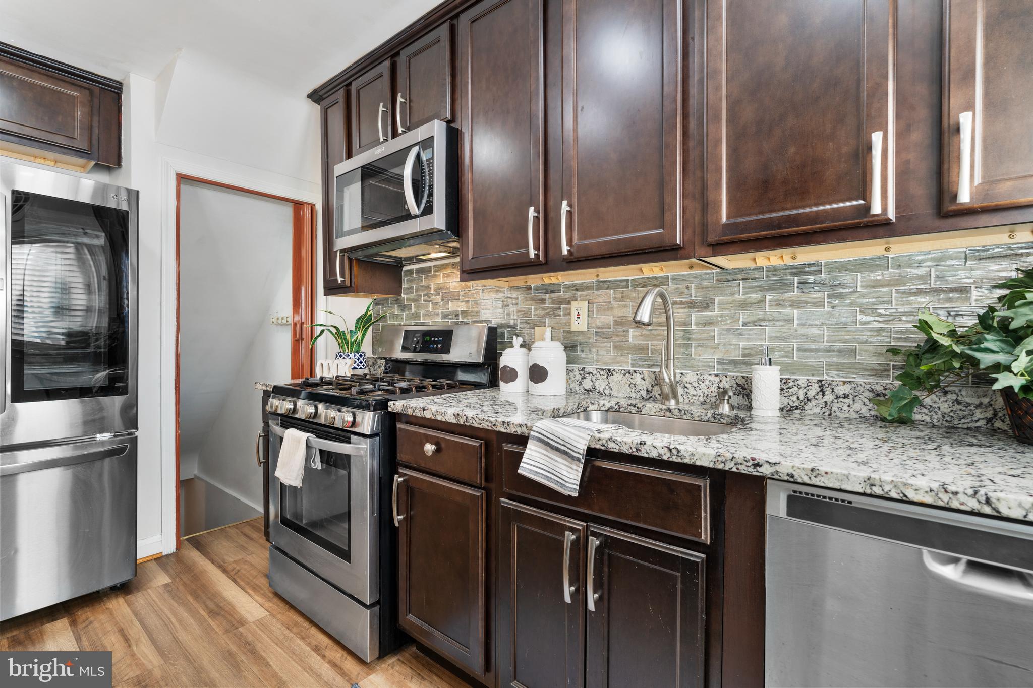 404 Grovethorn Road Baltimore, MD 21220 - Photo 15 of 39 a kitchen with stainless steel appliances granite countertop a stove a refrigerator and a sink