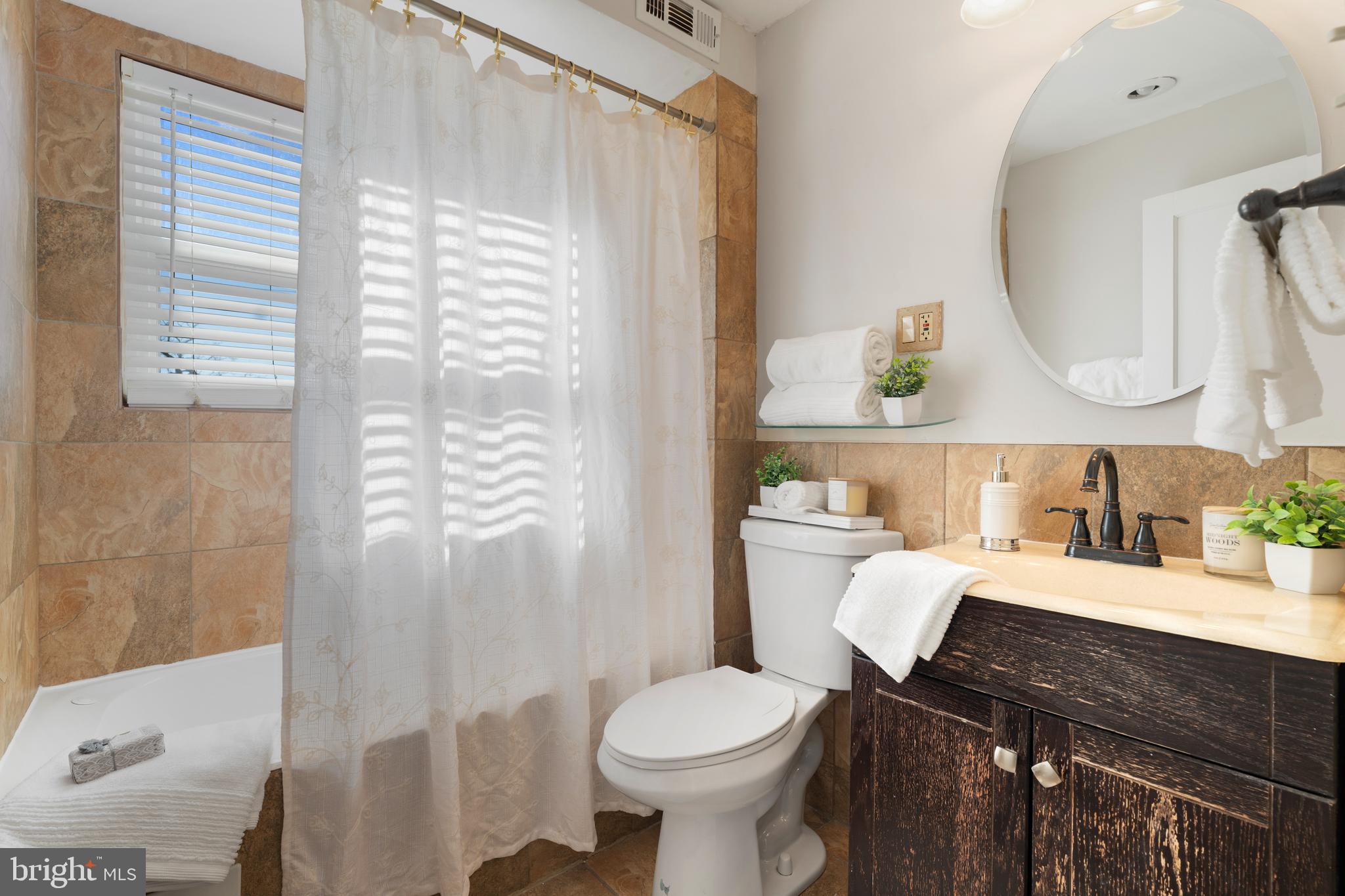 404 Grovethorn Road Baltimore, MD 21220 - Photo 19 of 39 a bathroom with a sink a toilet and a mirror
