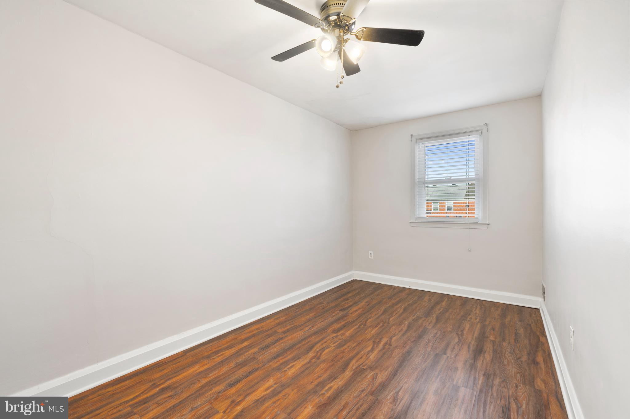 404 Grovethorn Road Baltimore, MD 21220 - Photo 21 of 39 an empty room with a window and wooden floor
