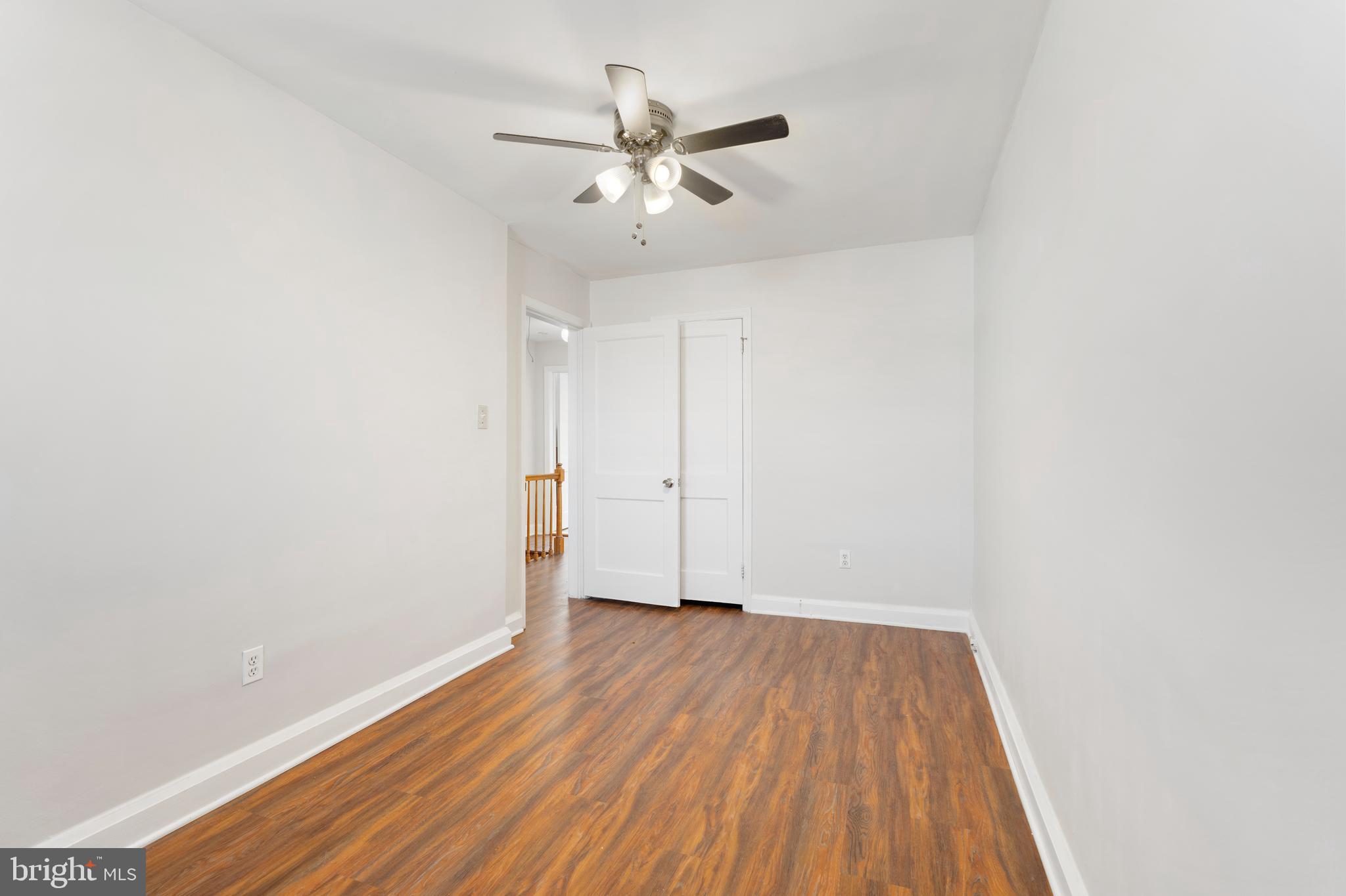 404 Grovethorn Road Baltimore, MD 21220 - Photo 22 of 39 an empty room with wooden floor and a ceiling fan