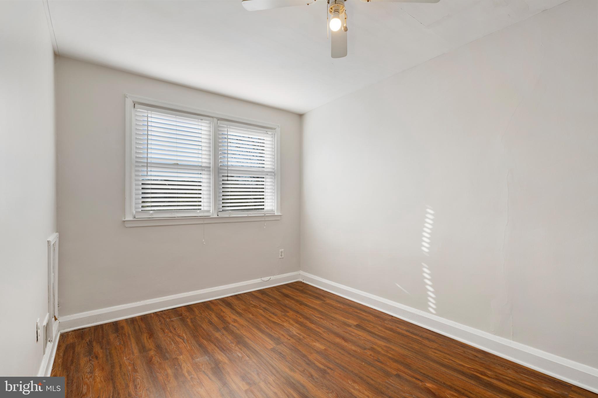 404 Grovethorn Road Baltimore, MD 21220 - Photo 23 of 39 an empty room with wooden floor and windows