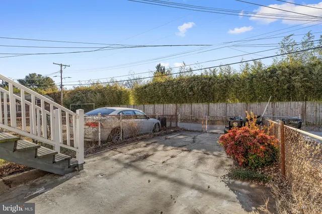 a backyard of a house with fire pit and furniture