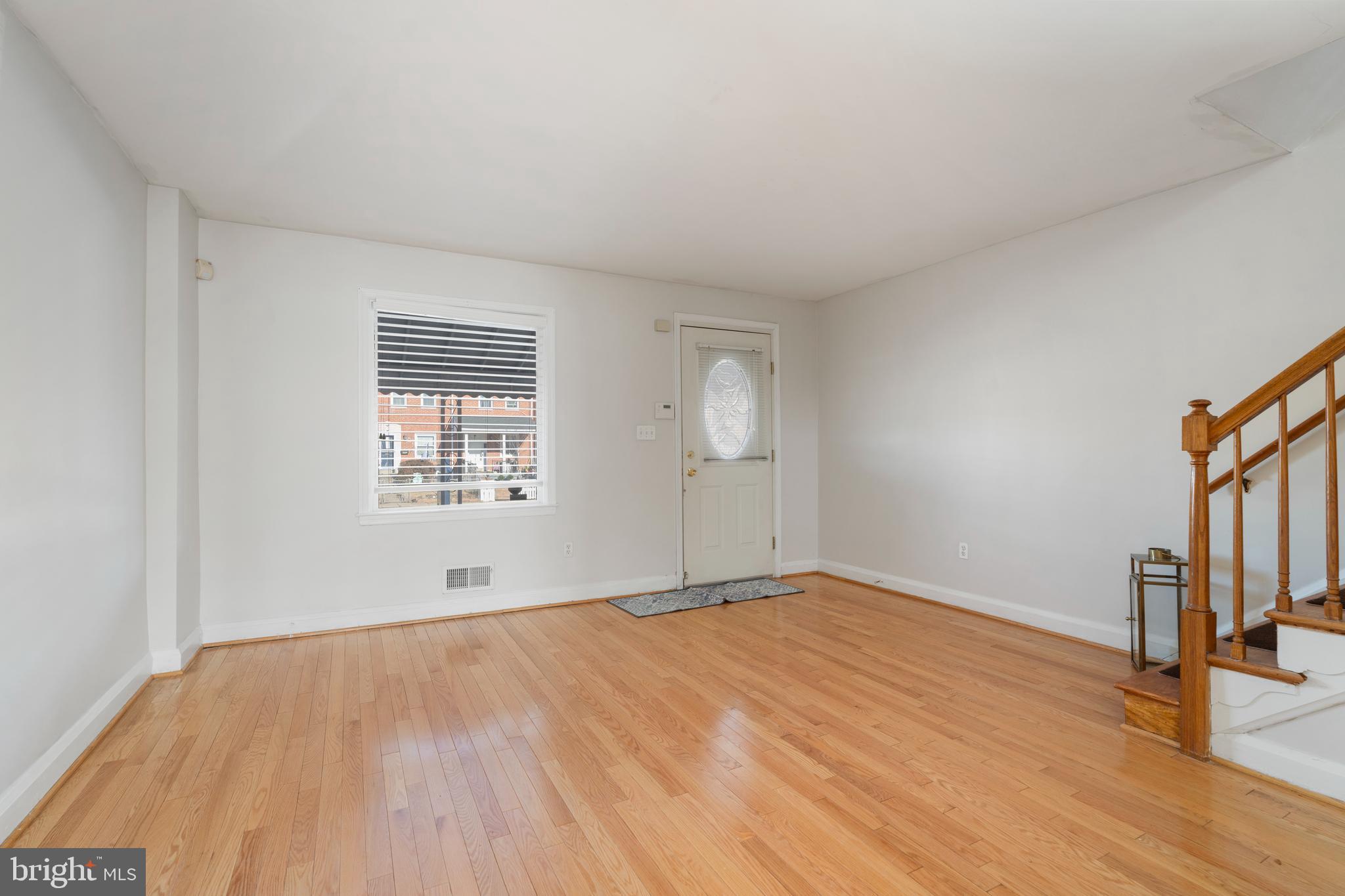 404 Grovethorn Road Baltimore, MD 21220 - Photo 6 of 39 an empty room with wooden floor and windows