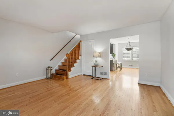 a view of empty room with wooden floor