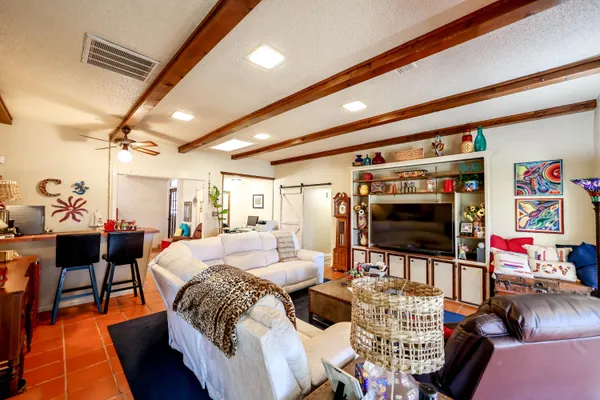 a view of a livingroom with wooden floor and furniture