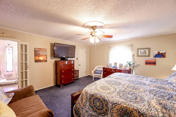 a bedroom with a bed and a chandelier