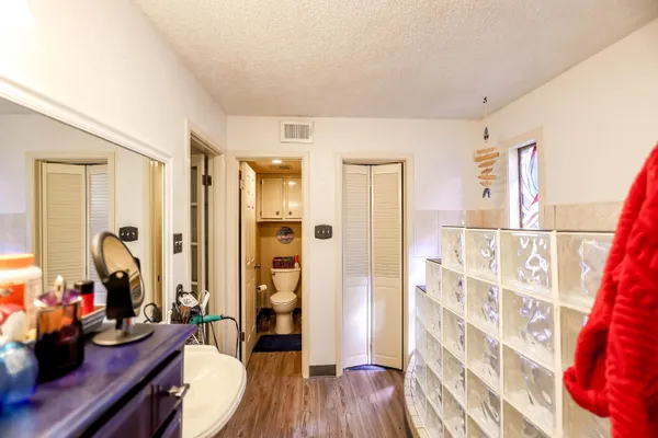 a bedroom with furniture and wooden floor