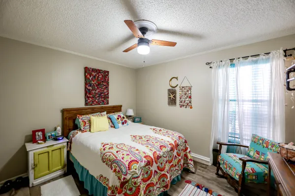 a bedroom with furniture and a flat screen tv