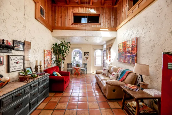 a view of a dining room with furniture and a chandelier fan
