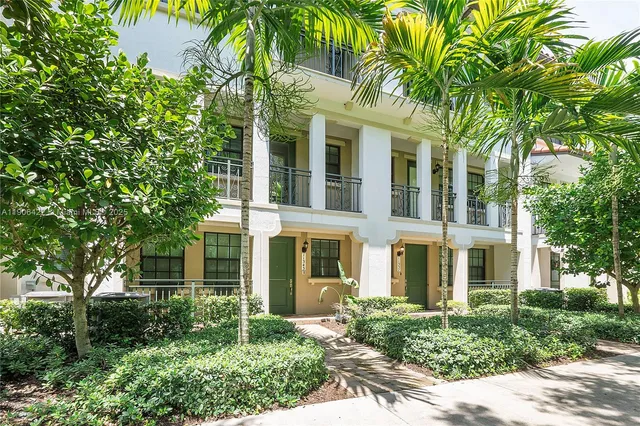front view of a brick house with a small yard